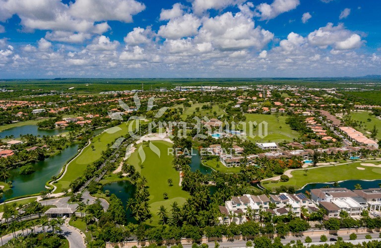 Aerial view of the Cocotal golf course, lakes, and surrounding roofs