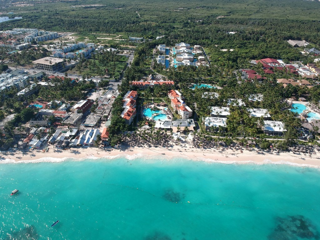 Aerial view of beach hotels, palms, and turquoise water